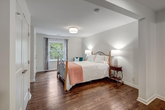 bedroom featuring dark hardwood / wood-style flooring