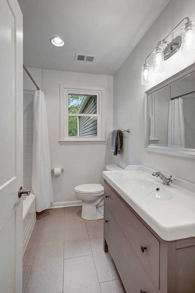 full bathroom with tile patterned flooring, vanity, toilet, and shower / bath combo with shower curtain