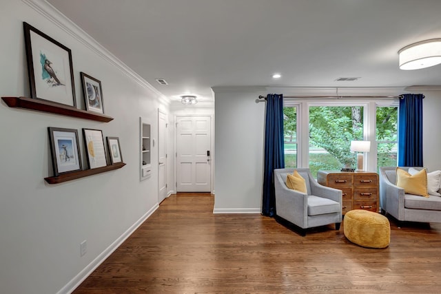 living area featuring dark hardwood / wood-style floors and crown molding