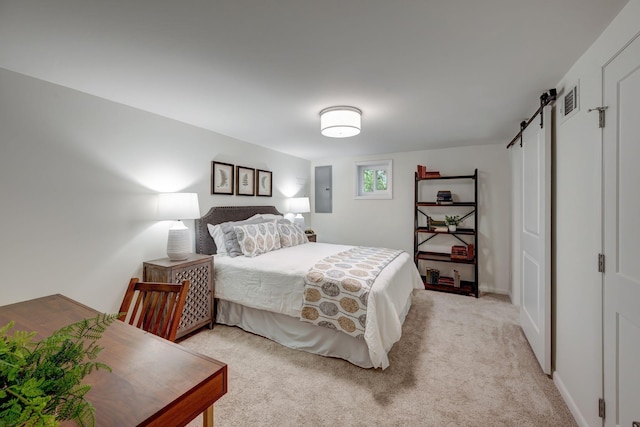 carpeted bedroom with a barn door and electric panel