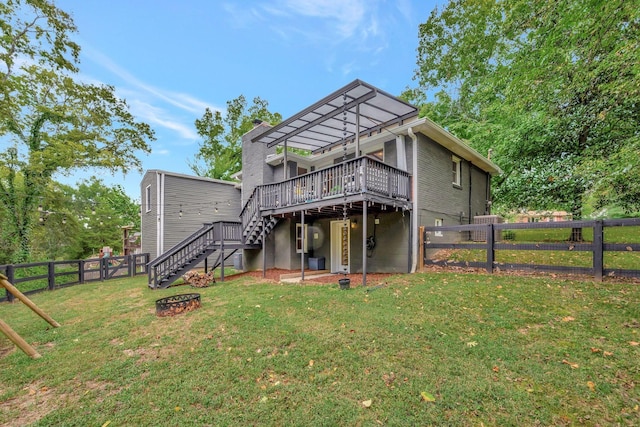 back of house with a yard and a deck