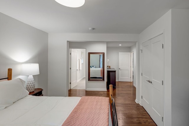 bedroom with hardwood / wood-style floors and a closet