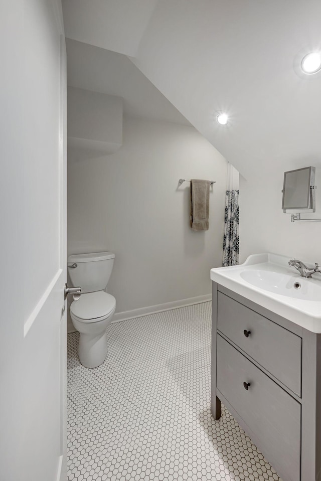 bathroom with tile patterned flooring, vanity, and toilet