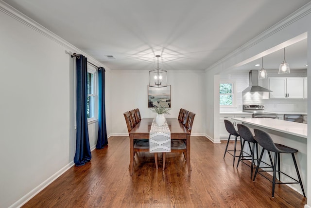 dining room featuring an inviting chandelier, dark wood-type flooring, and ornamental molding