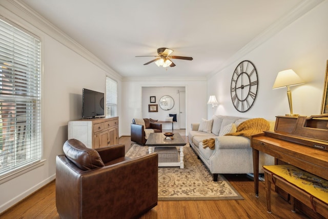 living room featuring crown molding, plenty of natural light, ceiling fan, and wood-type flooring