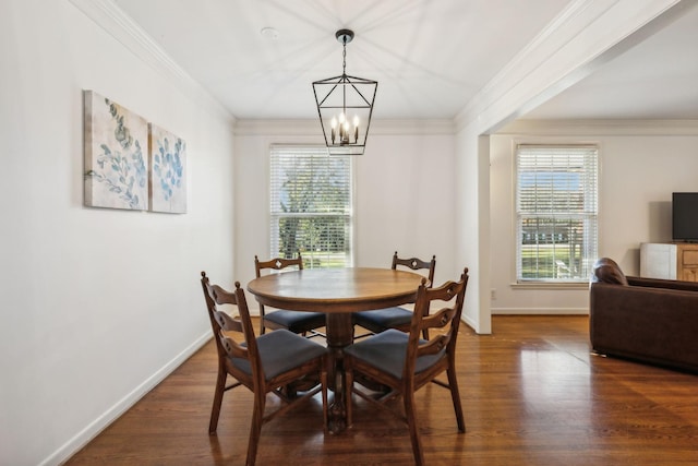 dining room featuring an inviting chandelier, dark wood-type flooring, and ornamental molding