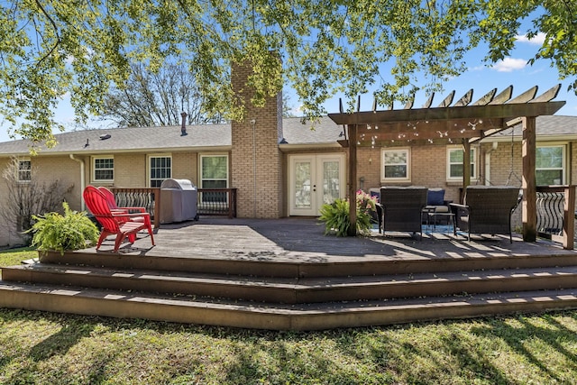 rear view of property featuring a deck, a pergola, and french doors