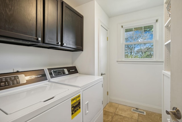 washroom with cabinets, independent washer and dryer, and light tile patterned floors