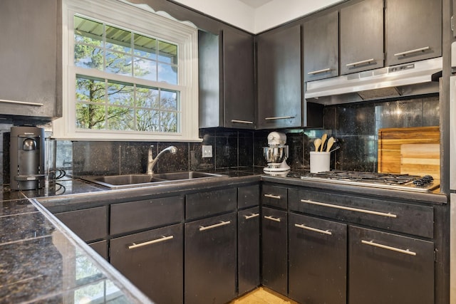 kitchen with decorative backsplash, sink, dark brown cabinets, and stainless steel gas cooktop