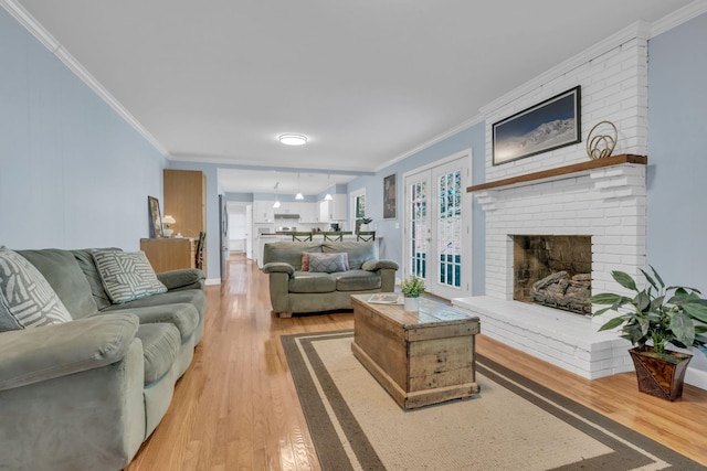 living room with crown molding and light hardwood / wood-style floors