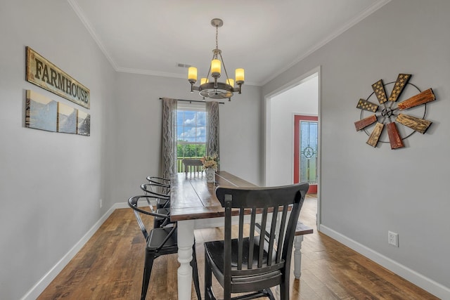 dining room featuring crown molding, a chandelier, and dark hardwood / wood-style floors