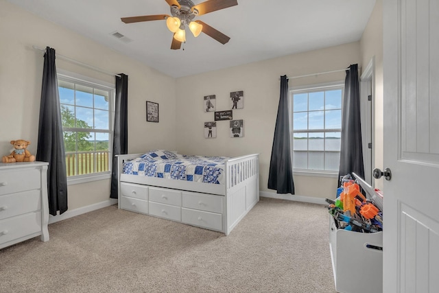 bedroom featuring light carpet and ceiling fan