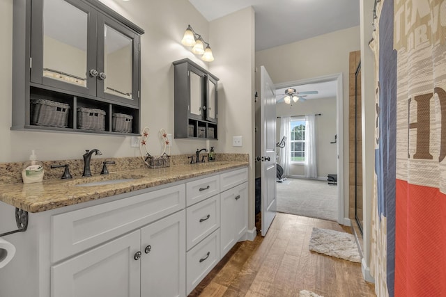 bathroom featuring hardwood / wood-style floors, vanity, ceiling fan, and a shower with shower door