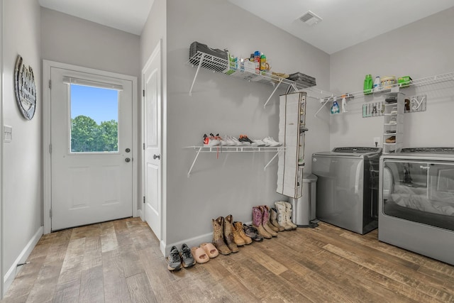 washroom featuring hardwood / wood-style floors and separate washer and dryer