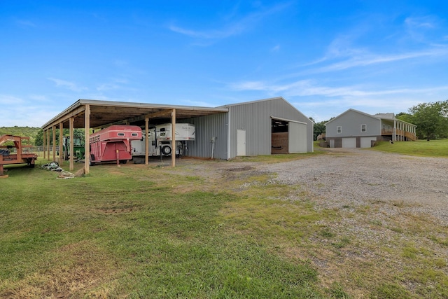 rear view of house with a garage and an outdoor structure