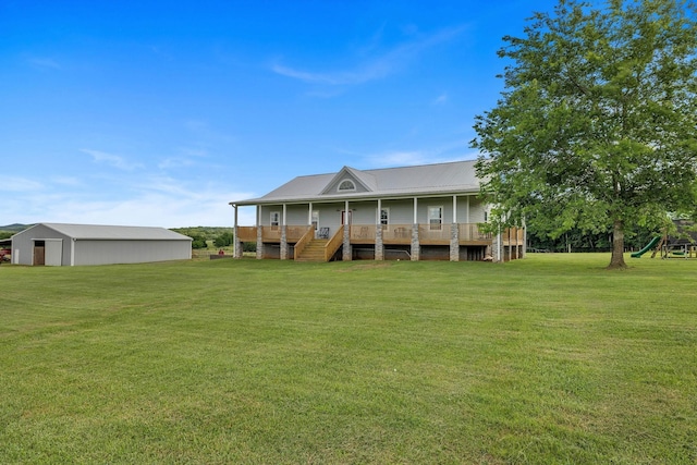 back of property featuring an outdoor structure and a lawn