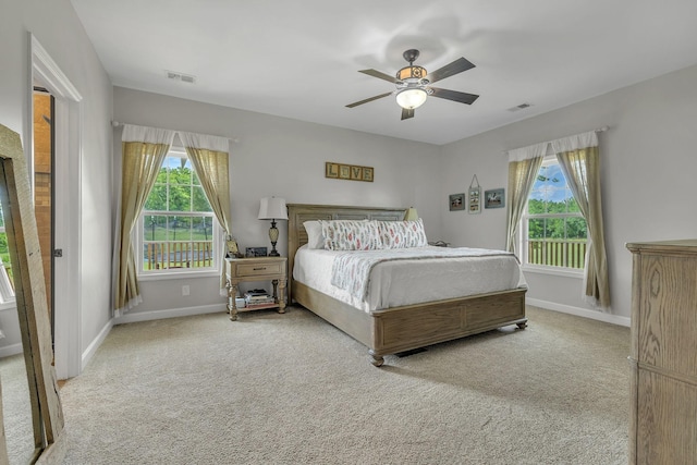 bedroom featuring ceiling fan and light carpet