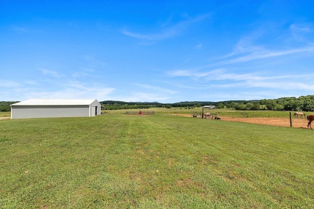 view of yard featuring a rural view and an outdoor structure