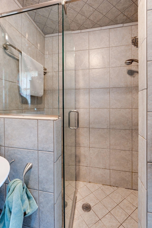 bathroom with a shower with door