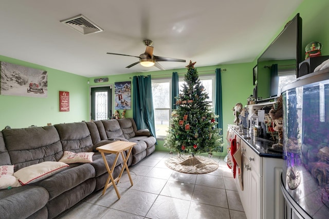 living room featuring ceiling fan and light tile patterned floors