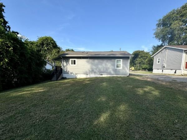 view of property exterior with a yard