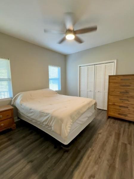 bedroom featuring dark hardwood / wood-style flooring, a closet, and ceiling fan