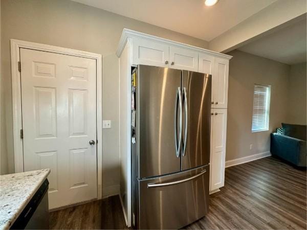 kitchen featuring dark hardwood / wood-style floors, light stone countertops, beamed ceiling, white cabinetry, and stainless steel refrigerator