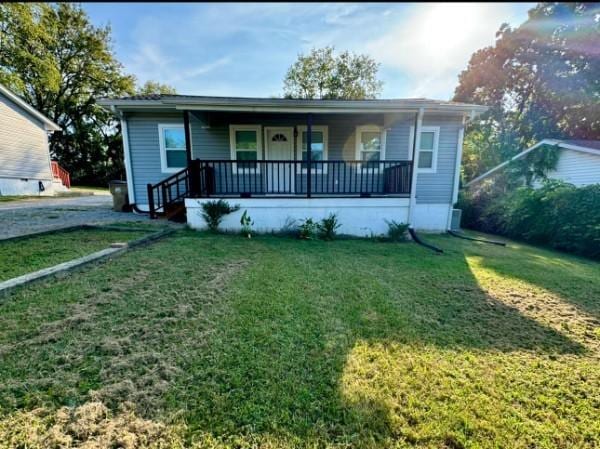 bungalow-style house featuring a front lawn and a porch