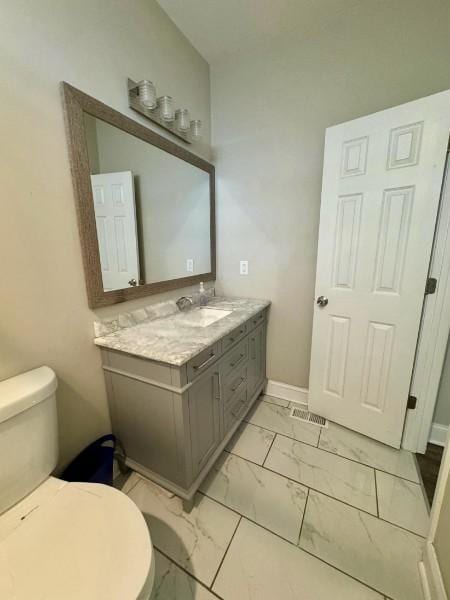 bathroom featuring vanity and toilet