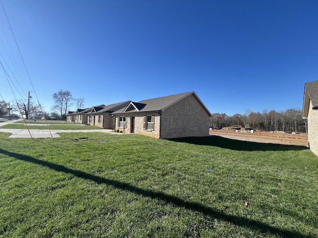 view of side of property with a lawn