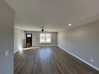 unfurnished living room featuring dark hardwood / wood-style floors and ceiling fan