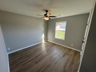 empty room with ceiling fan and dark wood-type flooring