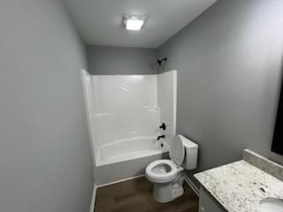 full bathroom with vanity, toilet, wood-type flooring, and bathtub / shower combination