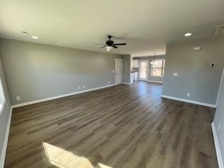 unfurnished living room with ceiling fan and dark wood-type flooring