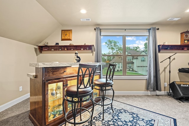 bar with carpet floors and lofted ceiling