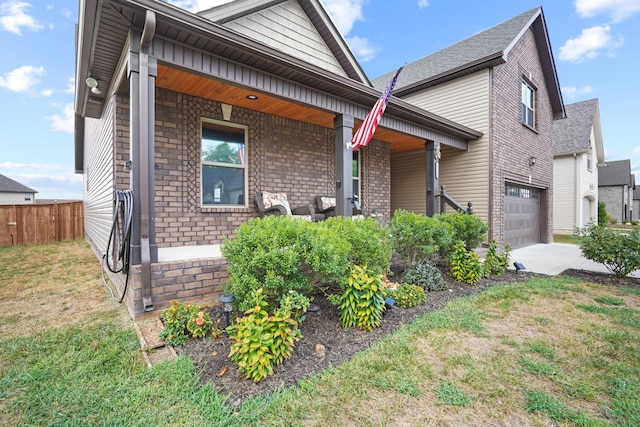 view of front facade with a porch, a garage, and a front yard