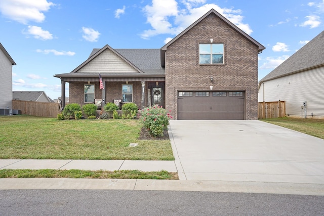 view of front of house with a garage, a front lawn, and central air condition unit