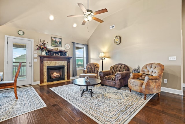 living room with dark hardwood / wood-style floors, ceiling fan, and high vaulted ceiling