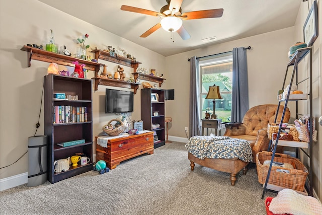 sitting room with carpet flooring and ceiling fan