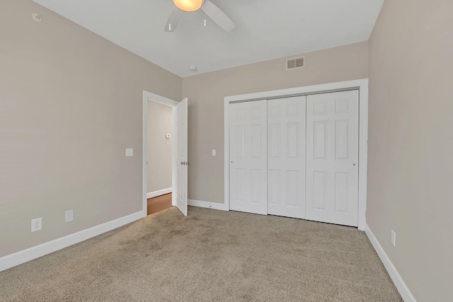 unfurnished bedroom with ceiling fan, a closet, and carpet floors