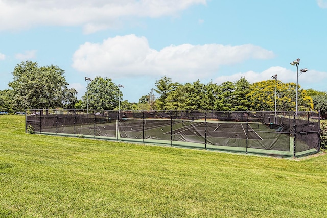 view of sport court with a yard