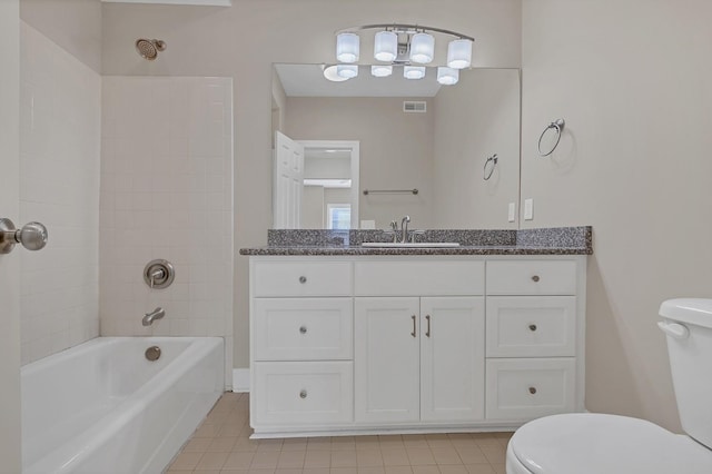 full bathroom with vanity, tile patterned flooring, tiled shower / bath, and toilet