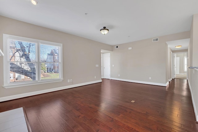 empty room featuring dark hardwood / wood-style flooring