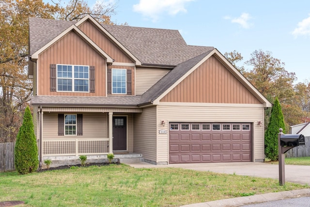 craftsman inspired home featuring covered porch, a garage, and a front lawn