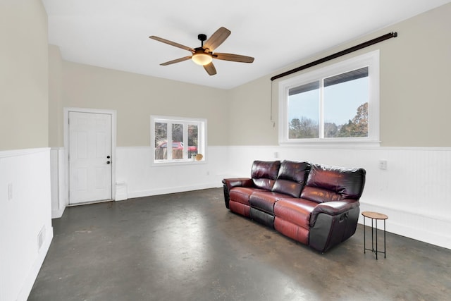 living room featuring plenty of natural light and ceiling fan