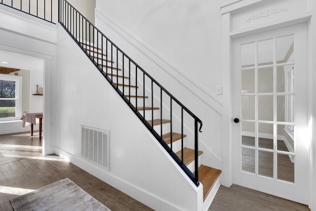 staircase with hardwood / wood-style flooring