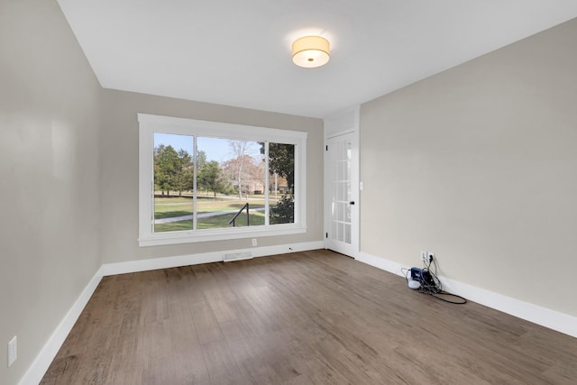 spare room with dark wood-type flooring