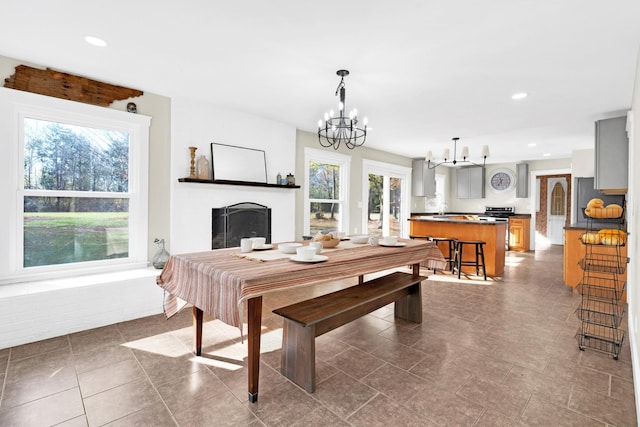 dining room with a notable chandelier, plenty of natural light, and french doors