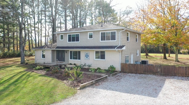 front facade featuring a front lawn and cooling unit