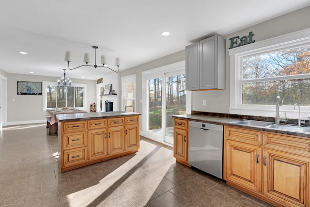 kitchen with stainless steel dishwasher, sink, and a wealth of natural light